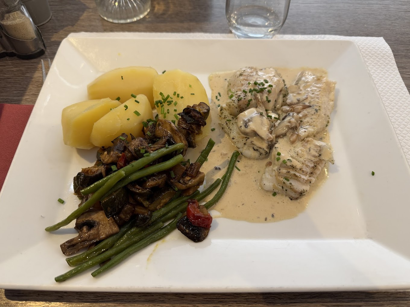 Filet de poisson nappé de sauce crémée aux champignons